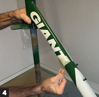 Lakering af cykelstel: Træk papiret forsigtigt af Lakering af cykelstel: Træk papiret forsigtigt af